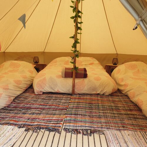 Glamping tent with a double bed and 2 single beds